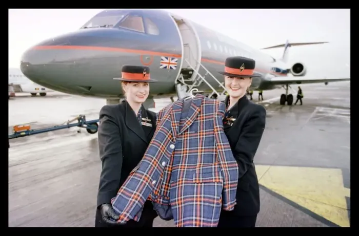 Framed Print : Rod Stewart tartan jacket December 1998 held by British Midland air stewardesses