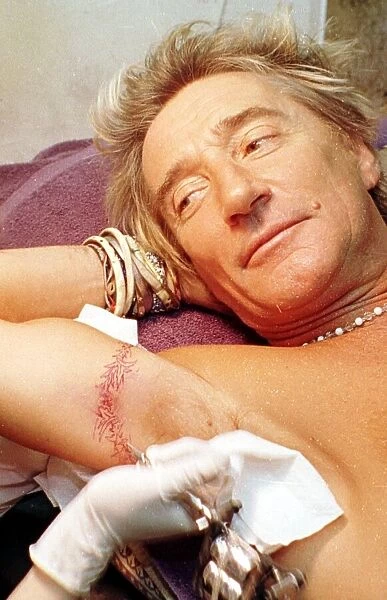 Rod Stewart watches finishing touches to thistle tattoo 21st June 1999 in