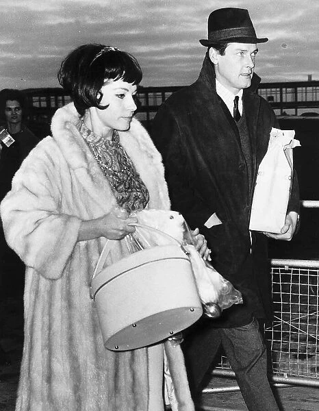 Roger Moore Actor at London Airport with friend Luisa Mattiolli