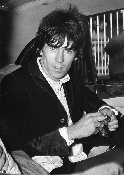 THE ROLLING STONES ARCHIVE Keith Richards sitting in rear of taxi cab - July 1967