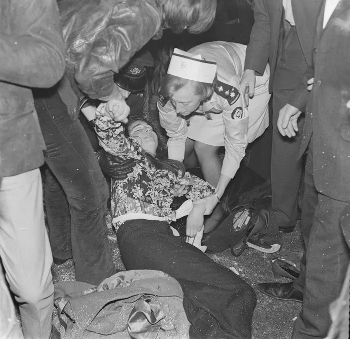 Framed Print : Rolling Stones. A fanlays on the ground being tended to by a St Johns Ambulance Brigade Framed Print : Rolling Stones. A fanlays on the ground being tended to by a St Johns Ambulance Brigade