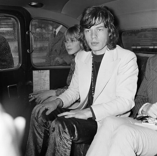 Rolling Stones lead singer Mick Jagger arrives at London Heathrow Airport with Marianne