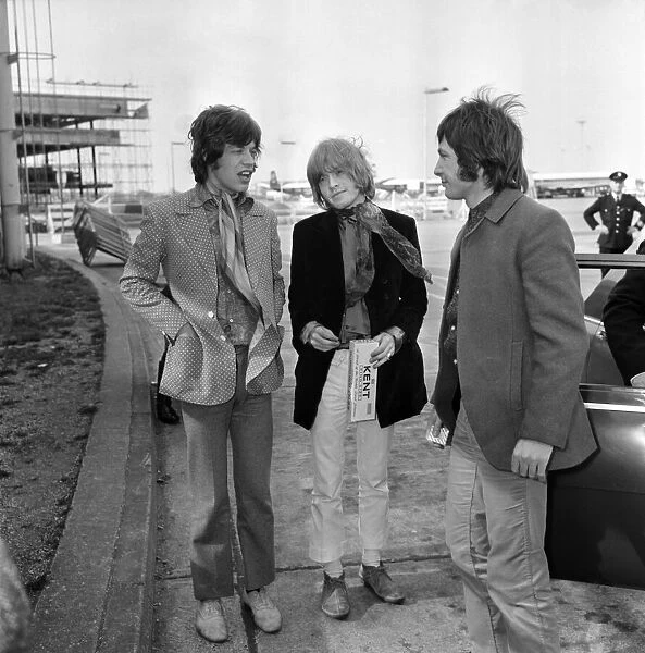 Rolling Stones: Mick Jagger, Brian Jones & Charlie Watts arrive at London Heathrow