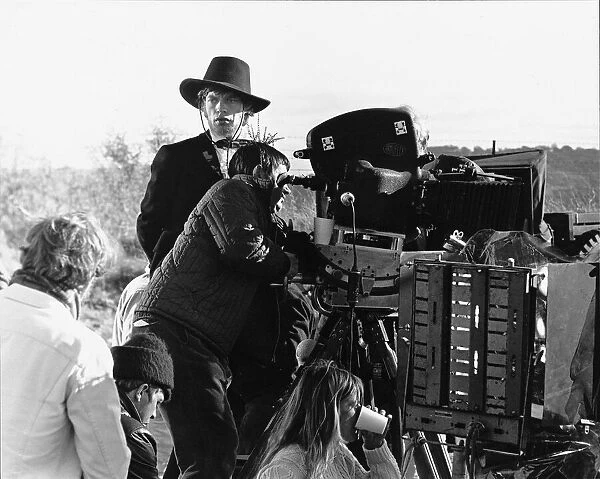 Rolling Stones Mick Jagger as Ned Kelly looks on as the crew prepare to shoot the next
