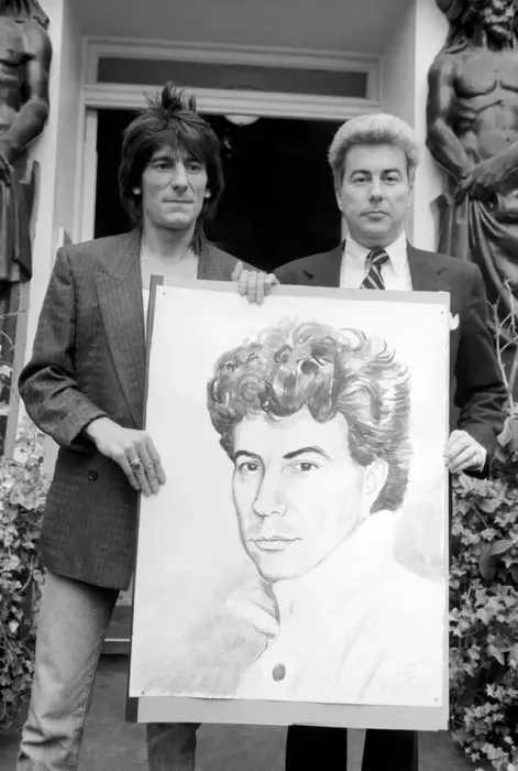 Framed Print : Rolling Stones: Ronnie Wood holds a painting of author Ken Follett who stands next to him Framed Print : Rolling Stones: Ronnie Wood holds a painting of author Ken Follett who stands next to him