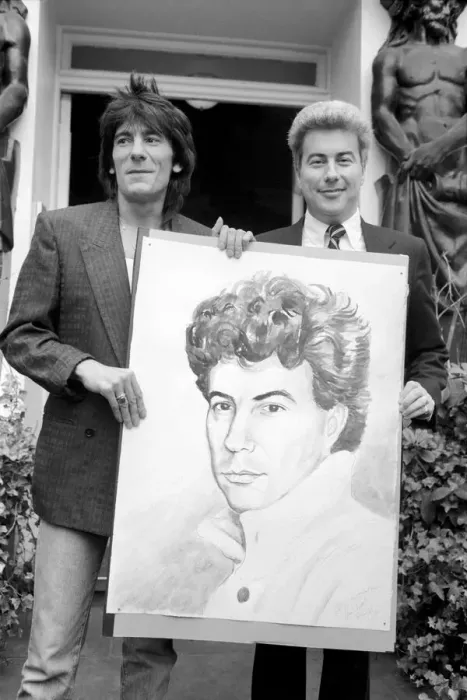 Framed Print : Rolling Stones: Ronnie Wood holds a painting of author Ken Follett who stands next to him Framed Print : Rolling Stones: Ronnie Wood holds a painting of author Ken Follett who stands next to him