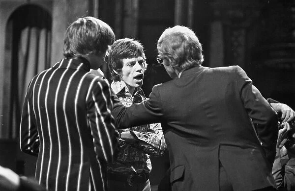 Rolling Stones singer Mick Jagger talking to his manager Andrew Oldham after refusing to