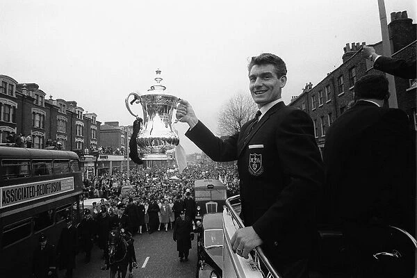 Ron Henry holds the FA Cup on the open top bus May 1962 during the Tottenham
