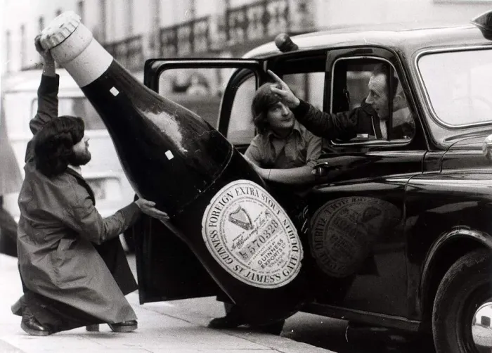 Framed Print : Ron Nicholson (left) Bill Barnard trying to get a large bottle of Guinness into a London Framed Print : Ron Nicholson (left) Bill Barnard trying to get a large bottle of Guinness into a London