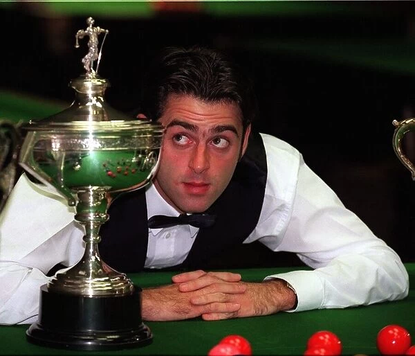 Ronnie O Sullivan snooker player September 1997 Looks at World Championship trophy