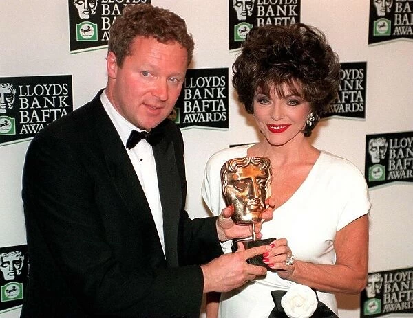Rory Bremner receives his BAFTA award for Best Light Entertainment performance from Joan
