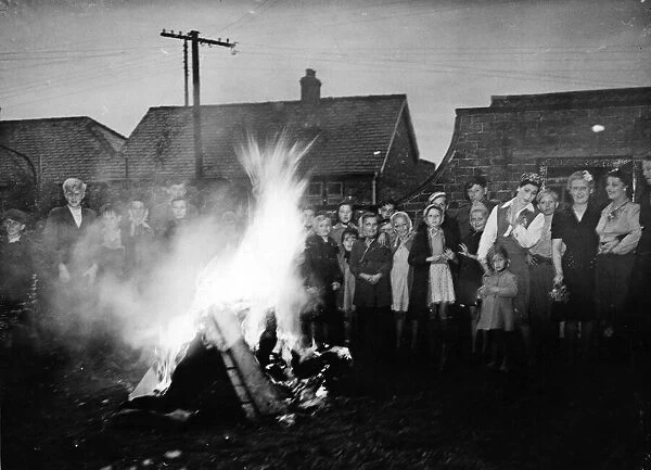 Round the victory bonfire at Sproatley, East Yorkshire. 8th May 1945