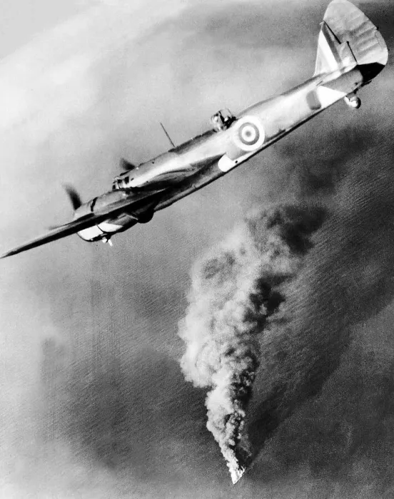 Framed Print : A Royal Air Force Bristol Beufighter aircraft flies over the burning hulk of a Framed Print : A Royal Air Force Bristol Beufighter aircraft flies over the burning hulk of a