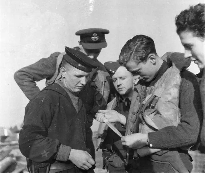 Framed Print : The Royal Air Force in Russia. The Wing of fighter Command seen examining a knife Framed Print : The Royal Air Force in Russia. The Wing of fighter Command seen examining a knife