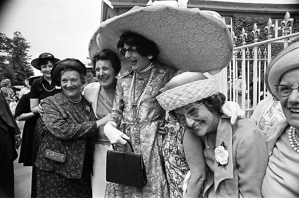 Royal Ascot, first day. Dame Edna Everage wearing a huge, five foot wide hat
