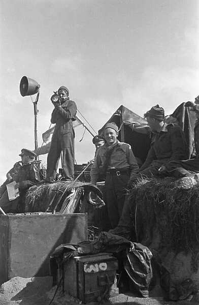 Royal Naval Division signallers send commands to merchant ships waiting to offload their