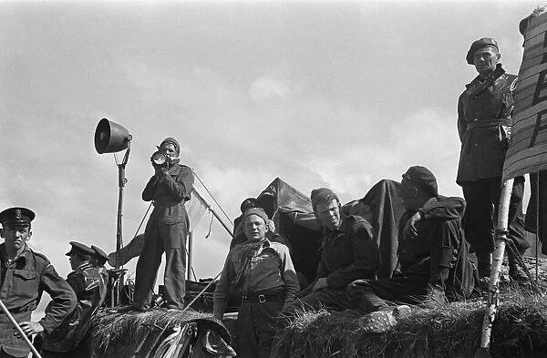 Royal Naval Division signallers send commands to merchant ships waiting to offload their