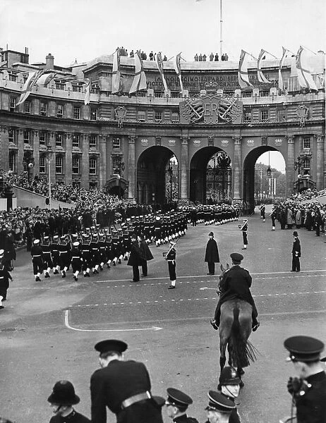 Royal Navy guard contingent make their way up The Mall passing under Admiralty Arch to