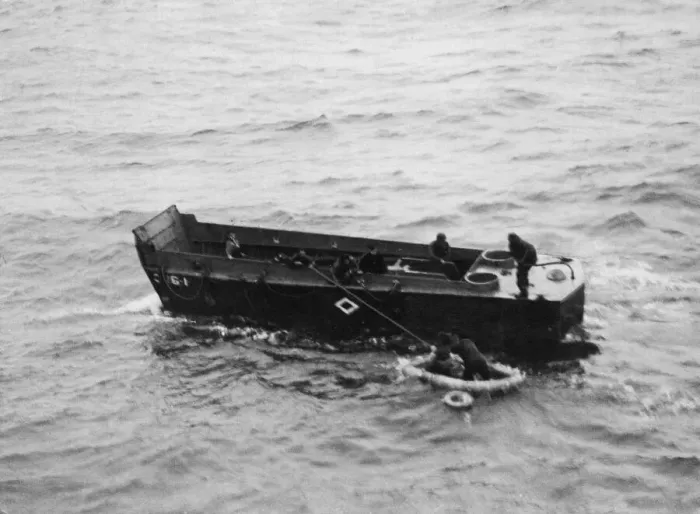 Framed Print : A Royal Navy landing craft picking up American survivors in Invasion Bay following a