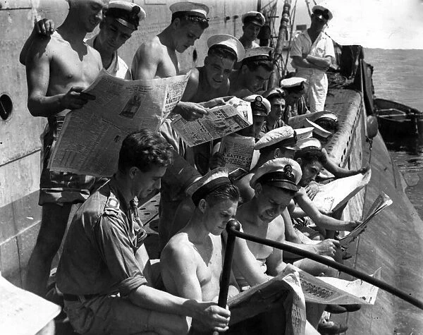 Royal Navy submariners in the Far East eagerly reading British Sunday newspapers