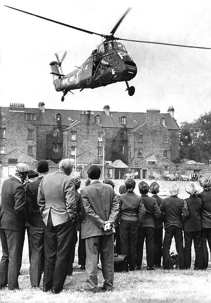 A Royal Navy Westland Wessex helicopter lands on the sportsfield of the Royal Grammar