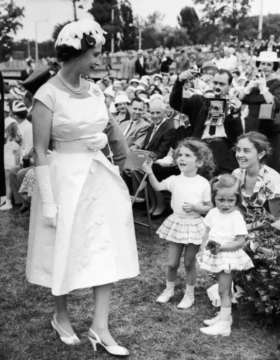 Framed Print : Royal Tour of Canada. The Queen receives a flower from a young girl after she had Framed Print : Royal Tour of Canada. The Queen receives a flower from a young girl after she had