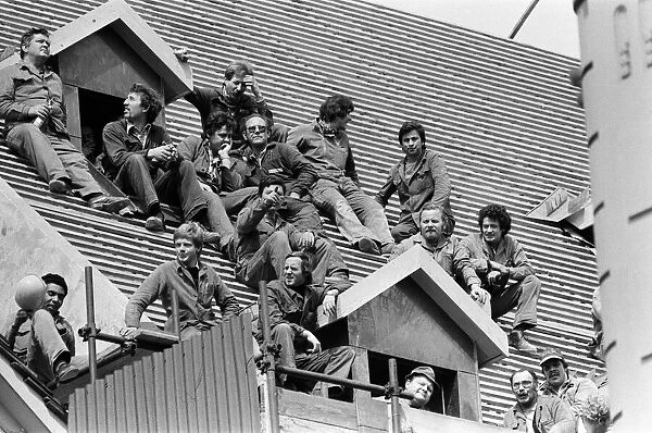 The royal tour of Switzerland. Pictured, locals sitting on a roof hoping to see the royal