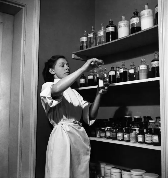 Framed Print : RSPCA Hospital. One of the nurse checks the medicine cabinet