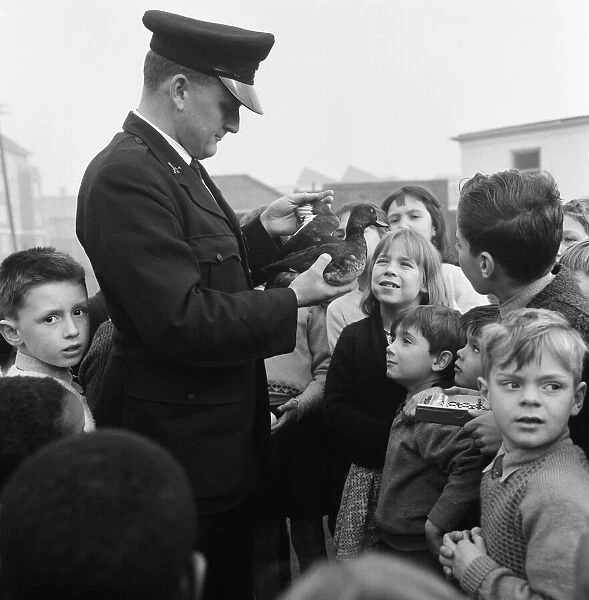RSPCA Inspector Geoffrey Coan pictured at work. He is watched by eager faced children at