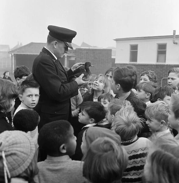 RSPCA Inspector Geoffrey Coan pictured at work. He is watched by eager faced children at