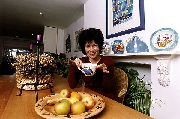 Ruby Wax TV Presenter sitting in her kitchen with a mug in her hand in Woodstock
