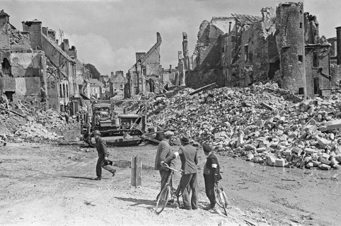 Framed Print : Ruined buildings and wrecked German transport in the streets of Montebourg as a result of