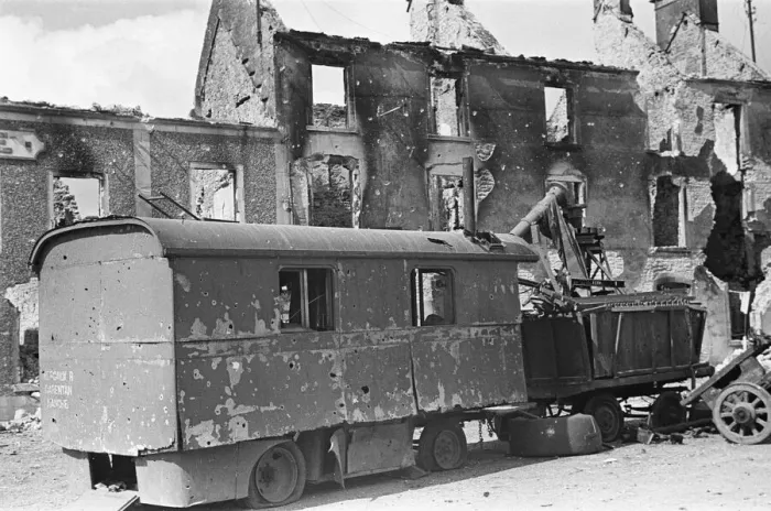 Framed Print : Ruined buildings and wrecked German transport in the streets of Montebourg as a result of