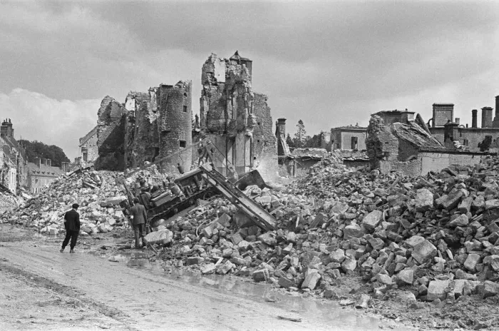 Framed Print : Ruined buildings and wrecked German transport in the streets of Montebourg as a result of
