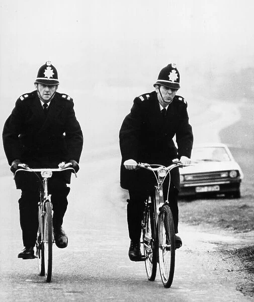 Two rural Police constables doing their rounds on bicycle at Newmarket, Cambridgeshire