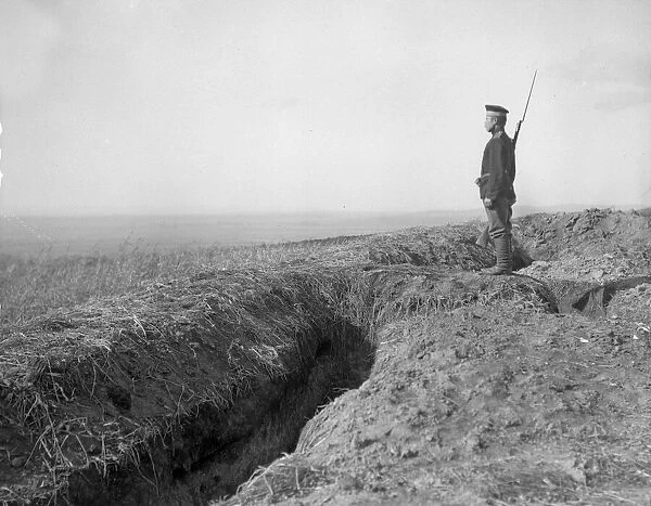 Russian sentry stands guard over trenches overlooking the village of Halicz