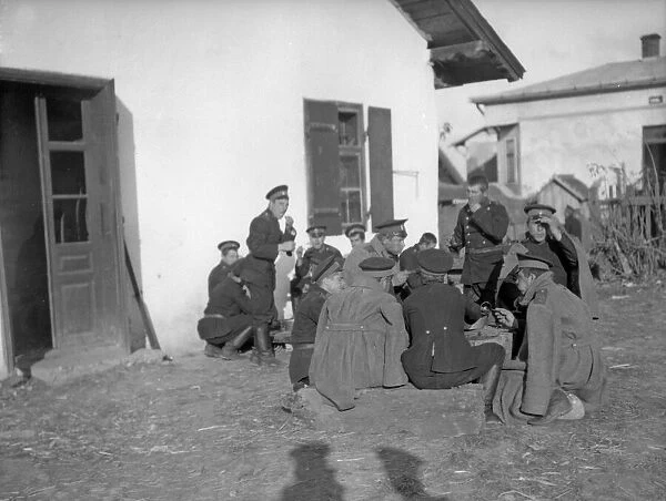Russian soldiers seen here eating supper in a Galician village as the army advances