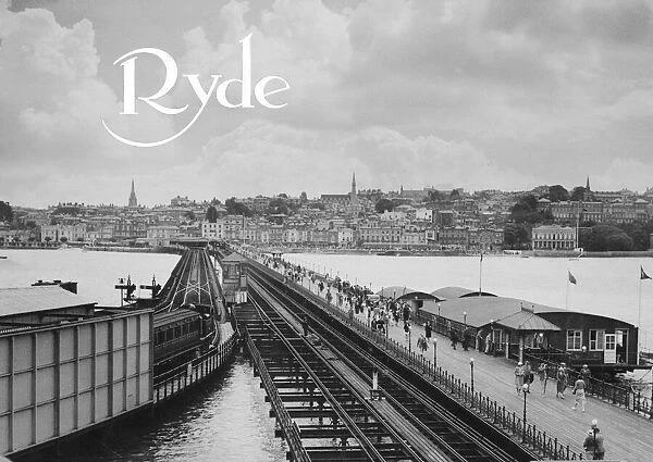 Ryde Esplanade and Pier, Isle of Wight. A steam train pulls out of the station on the end