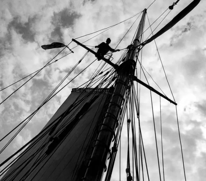 Framed Print : S. L. C. Latham, aged 17, astride the cross tree helping to send up the top mast a board Framed Print : S. L. C. Latham, aged 17, astride the cross tree helping to send up the top mast a board