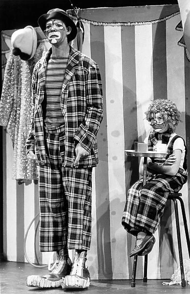 Two sad looking circus clowns, an adult and a young child. 26th September 1983
