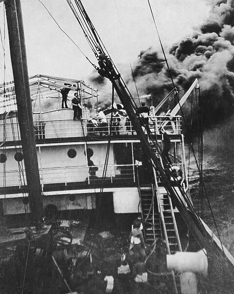 Sailors fight a fire aboard a British passenger cargo ship in the Atlantic as
