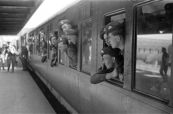 Sailors lean out of a train window as they depart for their ship. June 1947