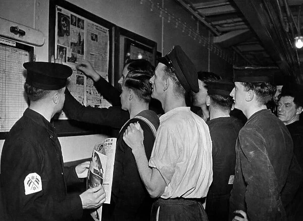 Sailors read the latest copy of Good Morning the newspapers for Submariners as it is