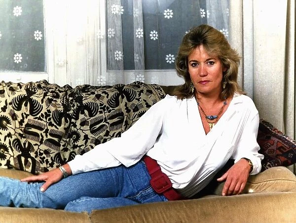 Sally Knyvette actress lying on sofa at her home April 1989