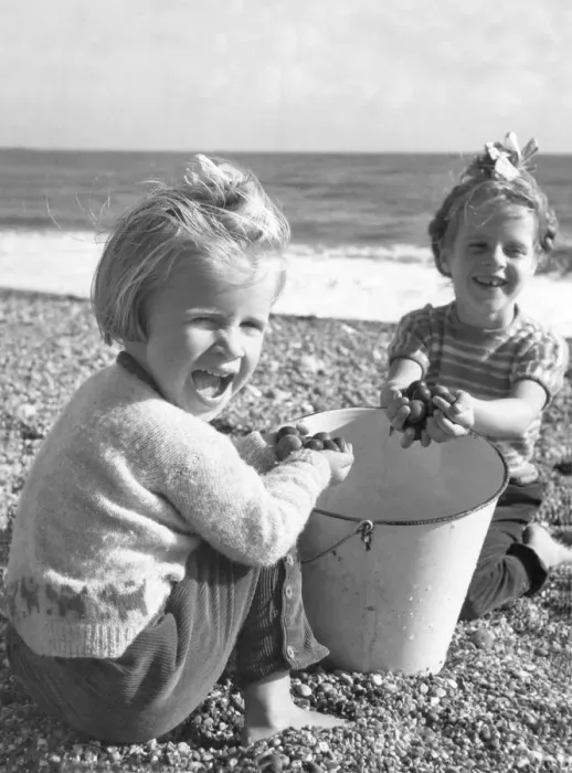 Framed Print : Sally Power 5 & her younger sister Rosemary Power, pictured playing on the pebble beach Framed Print : Sally Power 5 & her younger sister Rosemary Power, pictured playing on the pebble beach