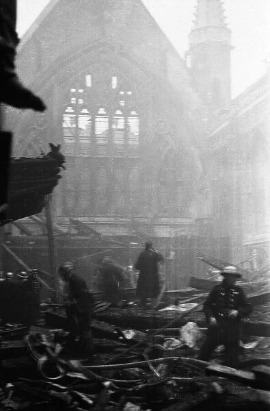 Salvage workers pick through the burnt out remains of London