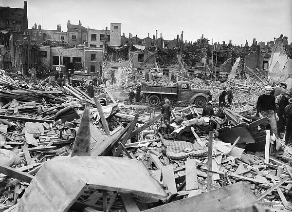 Salvage workers search through the debris follow a V1 Flying Bomb attack of Deptford