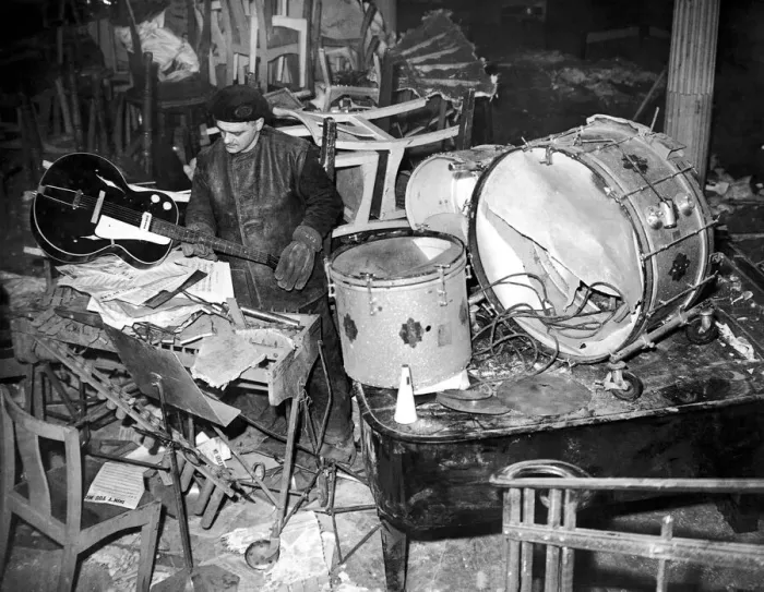Framed Print : Salvage workers sort through the damaged band instruments at the Cafe de Paris following