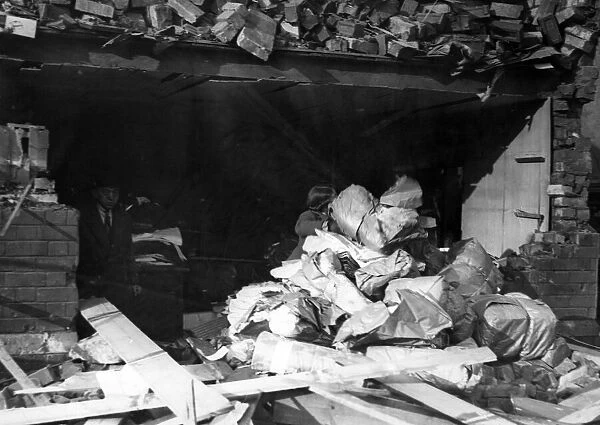 Salvaging stock in Canton, Cardiff, following a Nazi air raid. Circa 1941