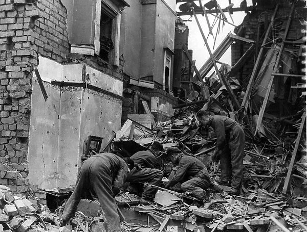 Salvaging amongst the wreckage of a dwelling which was damaged by Nazi raiders
